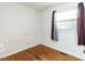 Simple bedroom with hardwood floors and a window at 301 King Arthur Trl, Garner, NC 27529