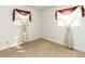 Well-lit bedroom with hardwood floors and two windows at 301 King Arthur Trl, Garner, NC 27529