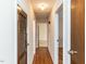 Long hallway with hardwood floors and access to bedrooms at 301 King Arthur Trl, Garner, NC 27529