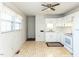 Bright kitchen featuring white cabinets and tile floor at 301 King Arthur Trl, Garner, NC 27529