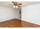 Hardwood floor living room with ceiling fan and door at 301 King Arthur Trl, Garner, NC 27529