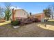 Home features a deck, grassy backyard, and shed at 307 E Jackson St, Mebane, NC 27302