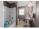 Clean bathroom with a shower/tub combo and pedestal sink at 307 E Jackson St, Mebane, NC 27302