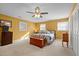 Bright bedroom with a queen bed, dresser, and ceiling fan at 307 E Jackson St, Mebane, NC 27302