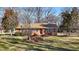 Brick ranch house with landscaped yard at 307 E Jackson St, Mebane, NC 27302