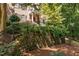 Charming brick home featuring a red front door, upper level balcony, and professionally landscaped front yard at 327 Davis Love Dr, Chapel Hill, NC 27517