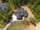 Bird's-eye view of a gray home with a manicured lawn, framed by mature trees at 3925 Cedar Knolls Dr, Youngsville, NC 27596