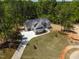 Expansive aerial view of a two-story home surrounded by lush trees and a spacious lawn at 3925 Cedar Knolls Dr, Youngsville, NC 27596