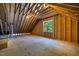 Unfinished attic space, showcasing exposed beams, natural light, and potential for customization at 3925 Cedar Knolls Dr, Youngsville, NC 27596