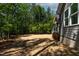 The exterior view captures the expansive backyard, complete with a screened porch, deck, and lush surroundings at 3925 Cedar Knolls Dr, Youngsville, NC 27596