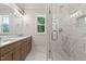 Luxurious primary bathroom with double vanity and walk-in shower with marble tile at 3925 Cedar Knolls Dr, Youngsville, NC 27596