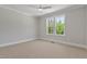 Bright bedroom with neutral carpet, ceiling fan, and double windows at 3925 Cedar Knolls Dr, Youngsville, NC 27596