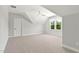 Light-filled bedroom with dormer windows, neutral carpet, and a ceiling fan at 3925 Cedar Knolls Dr, Youngsville, NC 27596