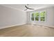 Bedroom with hardwood floors, ceiling fan, and sunny window view at 3925 Cedar Knolls Dr, Youngsville, NC 27596