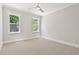 Bedroom features neutral carpet, two bright windows, and a ceiling fan at 3925 Cedar Knolls Dr, Youngsville, NC 27596