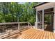 Outdoor deck surrounded by lush greenery offers a tranquil outdoor living space at 3925 Cedar Knolls Dr, Youngsville, NC 27596