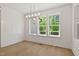 Dining area with shiplap walls, hardwood floors, and natural light from large windows at 3925 Cedar Knolls Dr, Youngsville, NC 27596