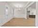 Elegant dining room featuring hardwood floors, stylish lighting, and wainscoting at 3925 Cedar Knolls Dr, Youngsville, NC 27596