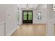 Bright and airy entryway with gleaming hardwood floors and a stylish light fixture at 3925 Cedar Knolls Dr, Youngsville, NC 27596