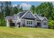 Attractive two-story home featuring gray siding, a well-maintained lawn, and stone accents at 3925 Cedar Knolls Dr, Youngsville, NC 27596