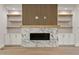 A modern fireplace stands out with a geometric wood feature above a white marble facade at 3925 Cedar Knolls Dr, Youngsville, NC 27596