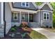 Inviting front porch with stone accents, neat landscaping, and a stylish black front door at 3925 Cedar Knolls Dr, Youngsville, NC 27596