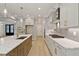 Spacious kitchen with island, stainless steel appliances, and sleek gray and white finishes at 3925 Cedar Knolls Dr, Youngsville, NC 27596