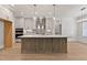Modern kitchen with island, stainless appliances, gray cabinets and white countertops at 3925 Cedar Knolls Dr, Youngsville, NC 27596