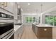 Bright kitchen with stainless appliances, island, pendant lights, and breakfast nook area at 3925 Cedar Knolls Dr, Youngsville, NC 27596
