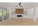 Bright living area showcasing a stylish fireplace, built-in shelving, and access to a deck at 3925 Cedar Knolls Dr, Youngsville, NC 27596