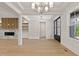 Spacious living room with fireplace, built-in shelves, and double front doors at 3925 Cedar Knolls Dr, Youngsville, NC 27596