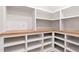 Walk-in pantry featuring custom white shelving and wood countertops for organized storage at 3925 Cedar Knolls Dr, Youngsville, NC 27596