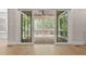 View of screened porch with wood ceiling and flooring, accessible through sliding glass doors at 3925 Cedar Knolls Dr, Youngsville, NC 27596
