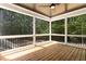 Screened-in porch with wood flooring and view of the surrounding trees at 3925 Cedar Knolls Dr, Youngsville, NC 27596