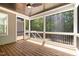Cozy screened porch with a ceiling fan, wood flooring and view of the surrounding woods at 3925 Cedar Knolls Dr, Youngsville, NC 27596