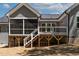 Rear exterior featuring a cozy screened-in porch and deck with white railing at 3925 Cedar Knolls Dr, Youngsville, NC 27596