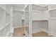 Spacious walk-in closet with custom shelving and wood floors, ideal for organization at 3925 Cedar Knolls Dr, Youngsville, NC 27596