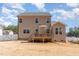 Rear view of house shows a cozy wood deck and bright windows overlooking a sprawling, enclosed backyard space at 40 Ironwood Blvd, Youngsville, NC 27596