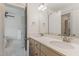 Bright bathroom featuring a double sink vanity with modern fixtures and a view to the bedroom at 40 Ironwood Blvd, Youngsville, NC 27596