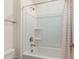 Bright bathroom with white tiled shower and tub featuring updated fixtures and shower curtain at 40 Ironwood Blvd, Youngsville, NC 27596