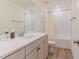 Bright bathroom features a large vanity with quartz counters, and a tiled shower at 40 Ironwood Blvd, Youngsville, NC 27596