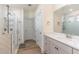 A stylish bathroom showcases a glass shower, quartz vanity, and modern herringbone tile at 40 Ironwood Blvd, Youngsville, NC 27596
