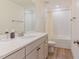 Updated bathroom featuring a vanity with solid countertops and a tiled shower at 40 Ironwood Blvd, Youngsville, NC 27596