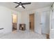 Neutral bedroom with modern ceiling fan and views to the en-suite bathroom at 40 Ironwood Blvd, Youngsville, NC 27596