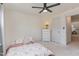 A bright bedroom is complemented by a ceiling fan, a soft mattress, and a chest of drawers at 40 Ironwood Blvd, Youngsville, NC 27596