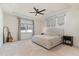 Serene bedroom featuring a tray ceiling, neutral décor, a large window, and plush carpeting at 40 Ironwood Blvd, Youngsville, NC 27596