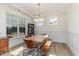 A charming dining room boasts natural light, modern wainscoting, and a rustic wood table at 40 Ironwood Blvd, Youngsville, NC 27596