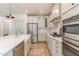 A modern kitchen features stainless steel appliances, white cabinetry, and a farmhouse sink at 40 Ironwood Blvd, Youngsville, NC 27596