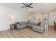 Open concept living room with a large sectional sofa and modern ceiling fan at 40 Ironwood Blvd, Youngsville, NC 27596