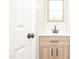 Nicely remodeled bathroom with a modern vanity and a square framed mirror, next to a door at 400 W H. Street St, Erwin, NC 28339